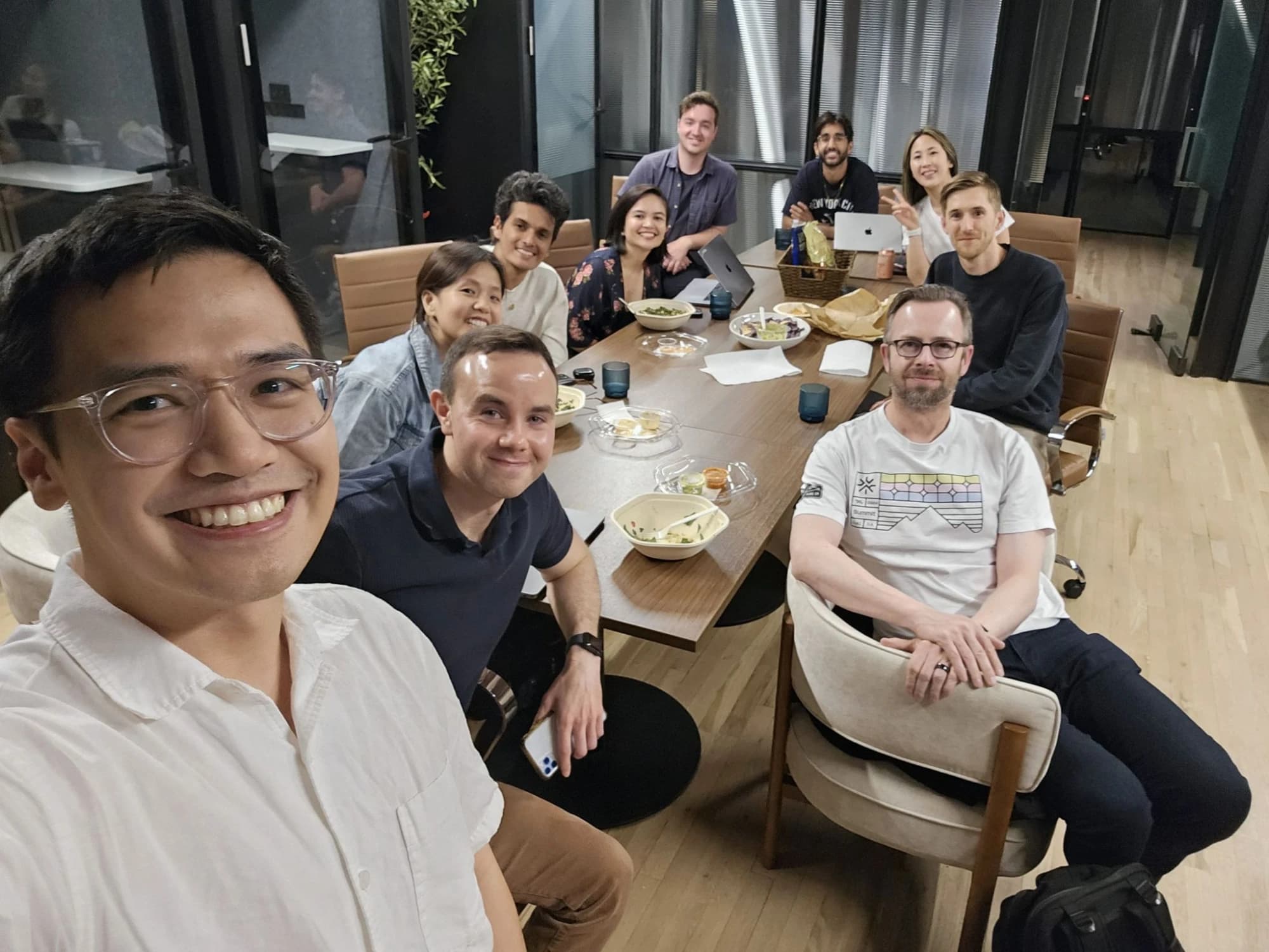 A small Time Rich Club gathering smiling around a conference table