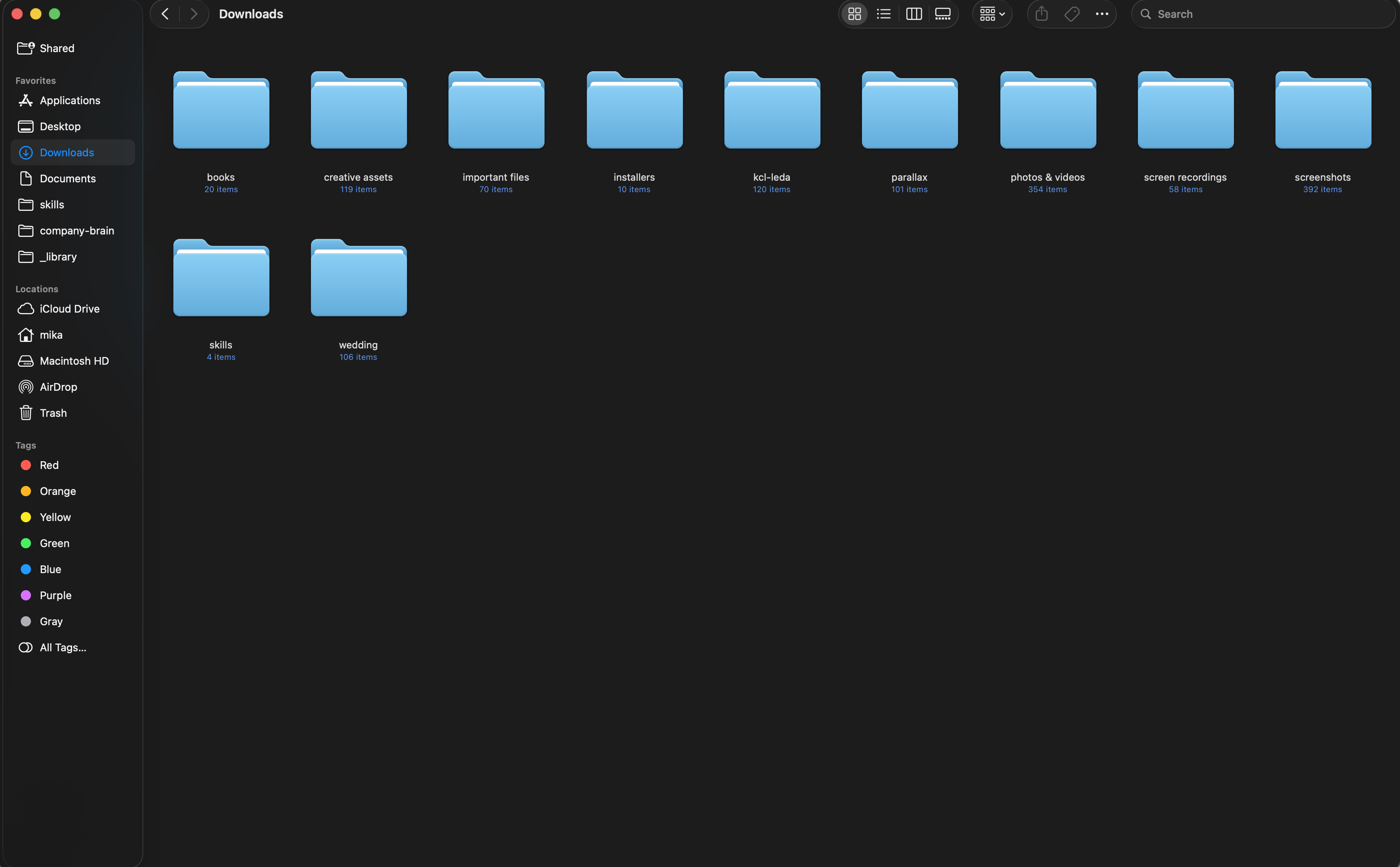 Organized Downloads folder with eleven cleanly labeled subfolders after Claude Cowork cleanup