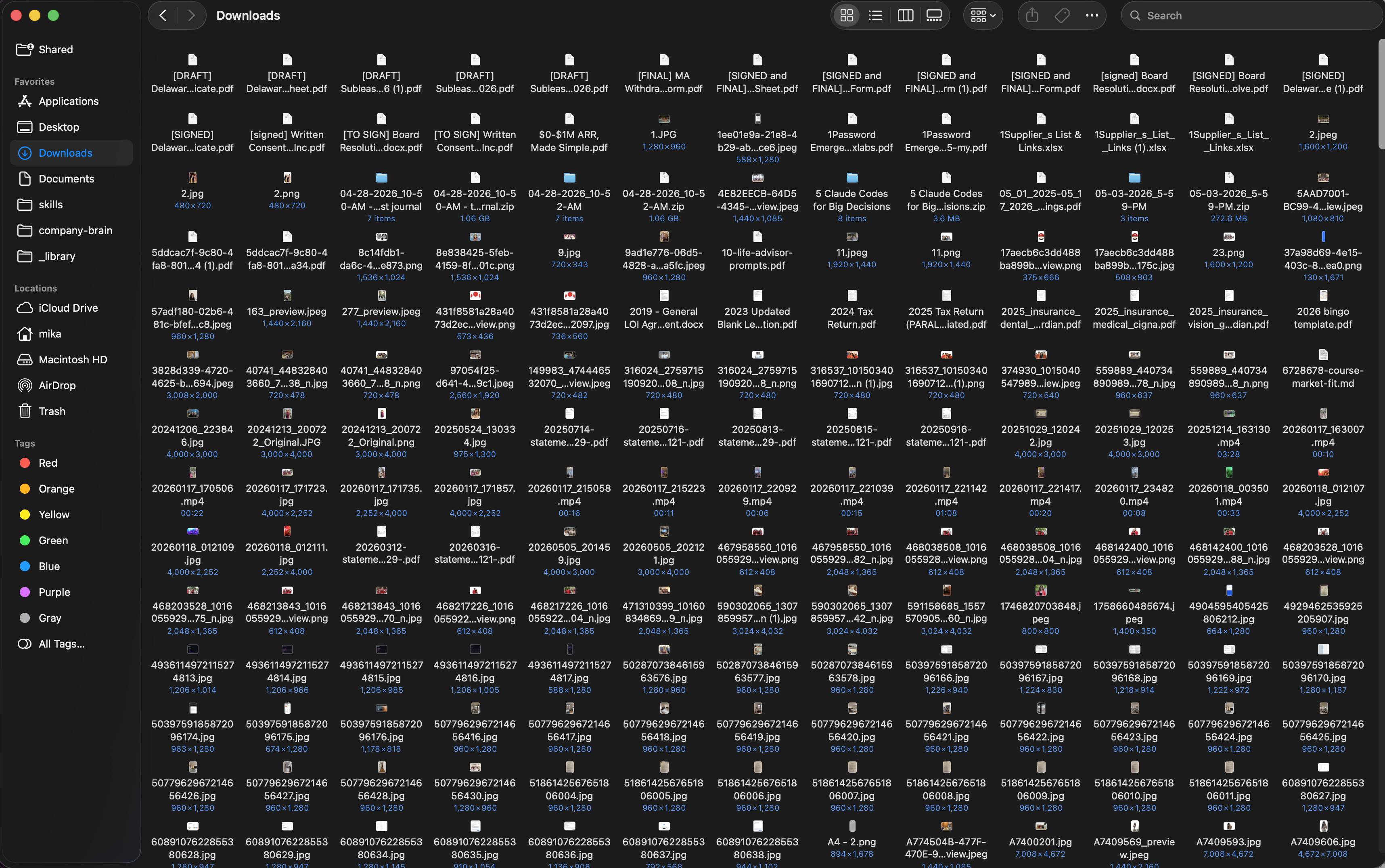Messy Downloads folder packed with loose screenshots, PDFs, and videos before Claude organized it