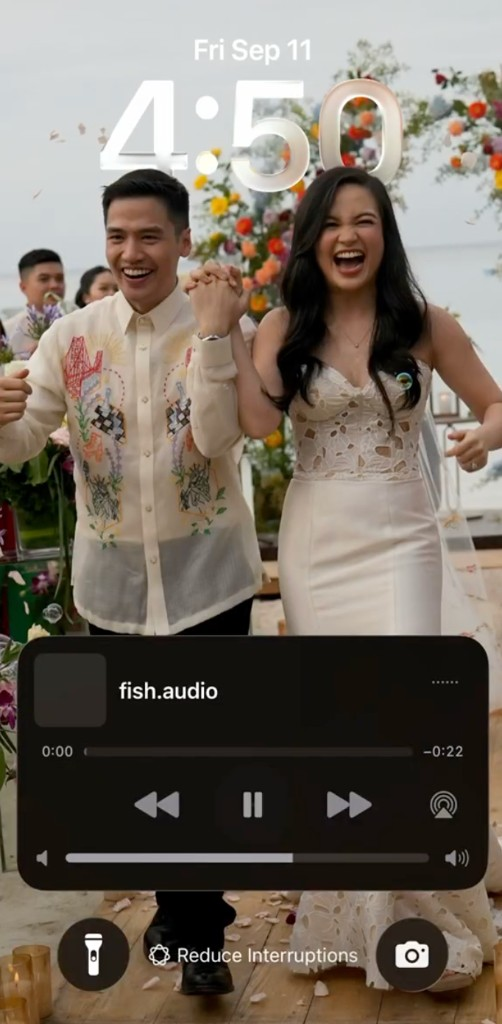 iPhone lock screen showing a fish.audio player with pause and skip controls